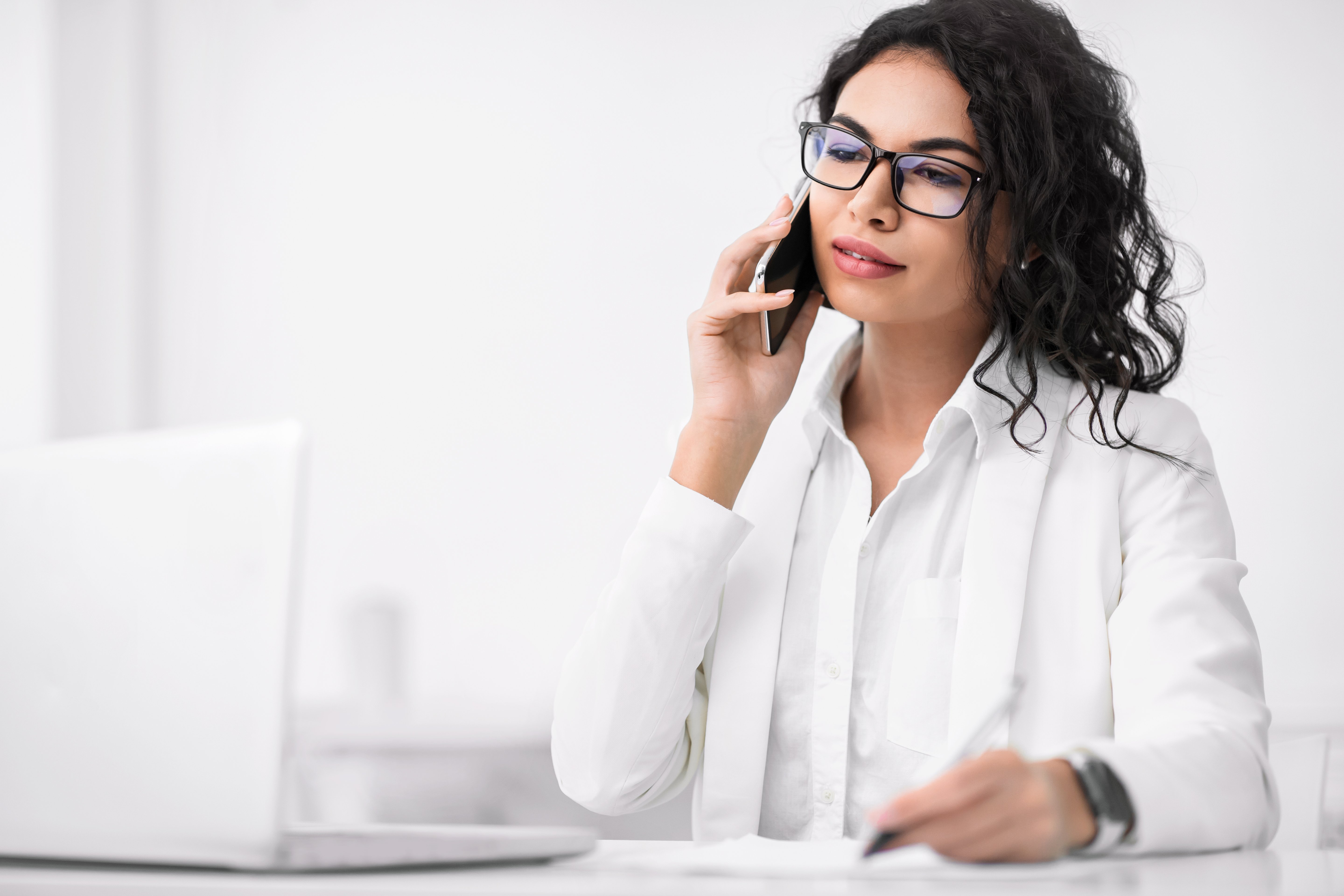 pensive-hispanic-businesswoman-talking-on-cell-pho-2022-12-16-08-58-53-utc